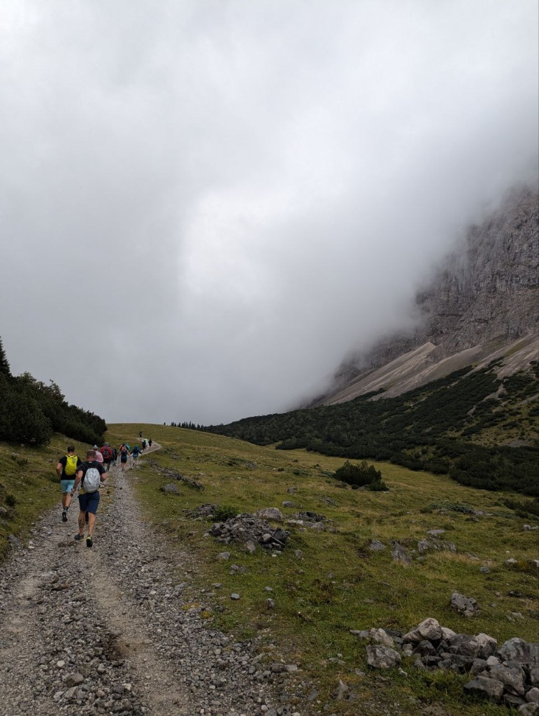 Runners heading into the misty Karwendel valley with limestone peaks