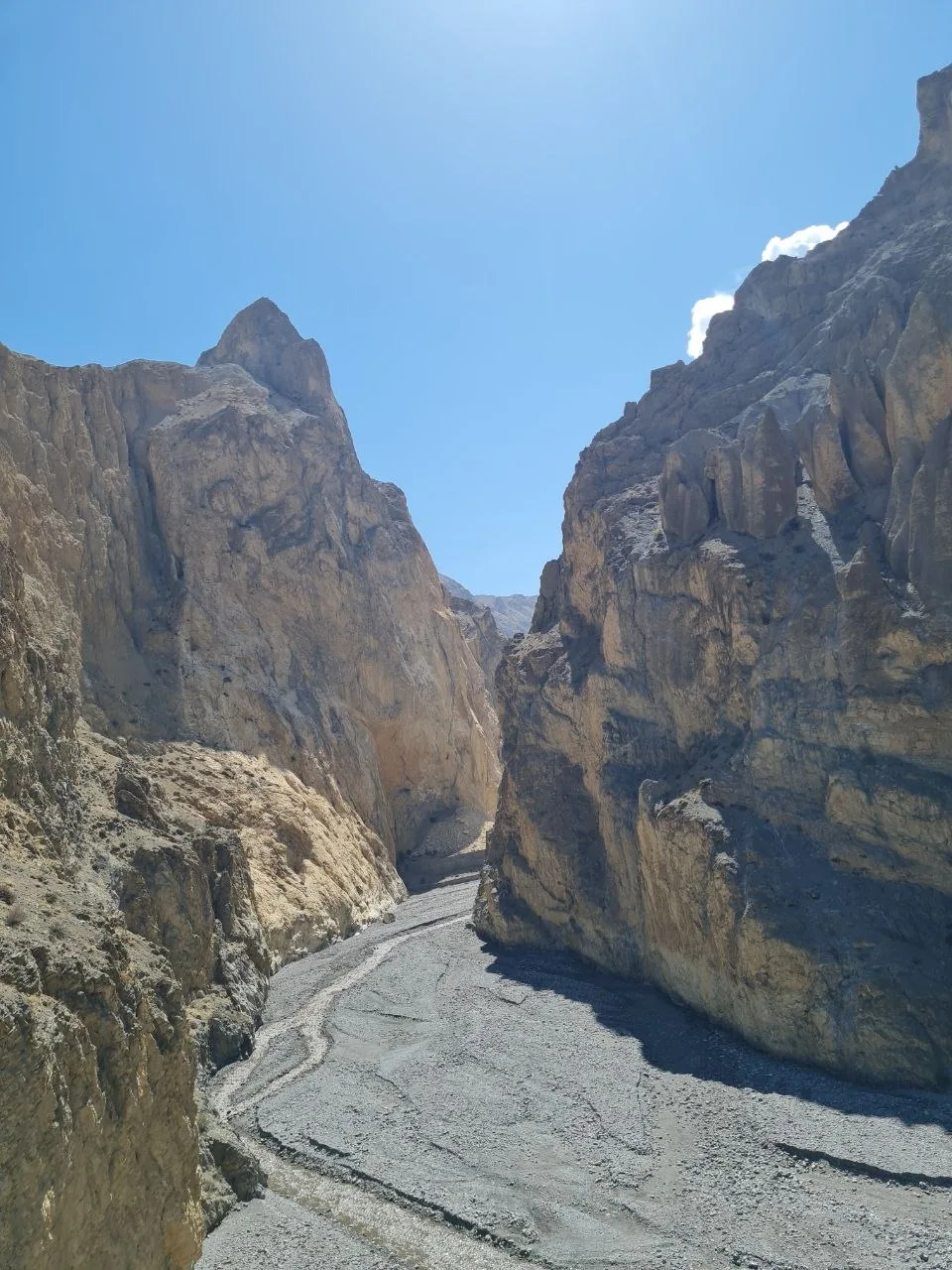 A dry riverbed canyon cuts deep through eroded sandstone walls in Mustang, Nepal.