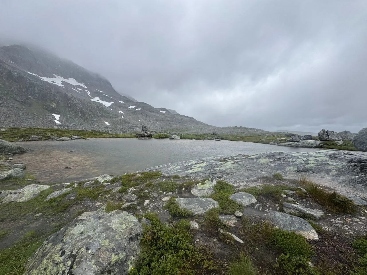 Foggy mountain pond on a rainy day
