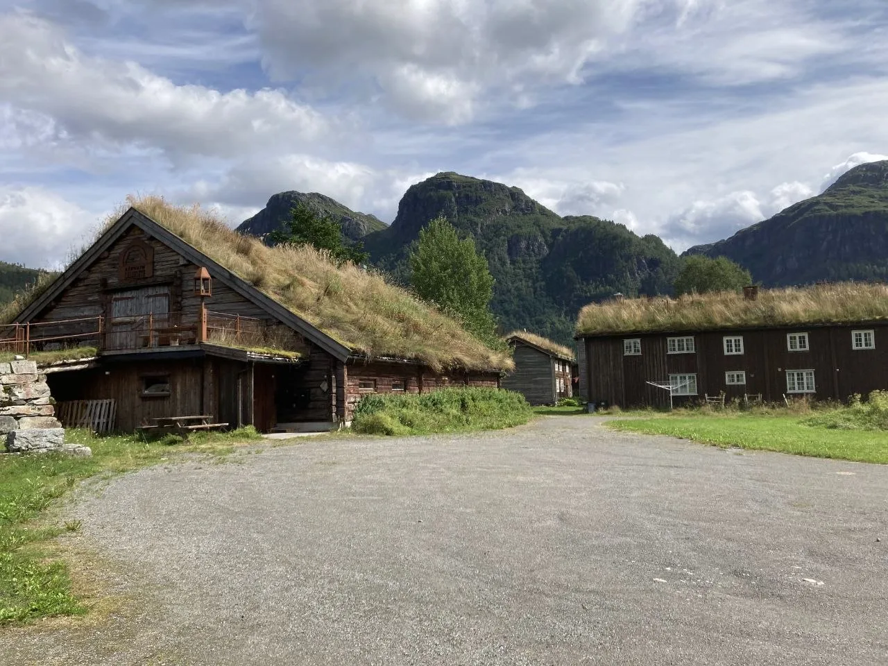 Historic huts with grassy roofs in mountain landscape