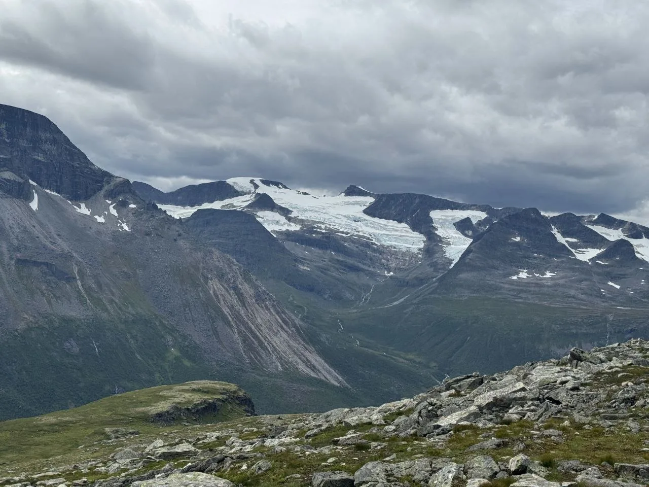 Cloud-covered glacier in rugged mountains