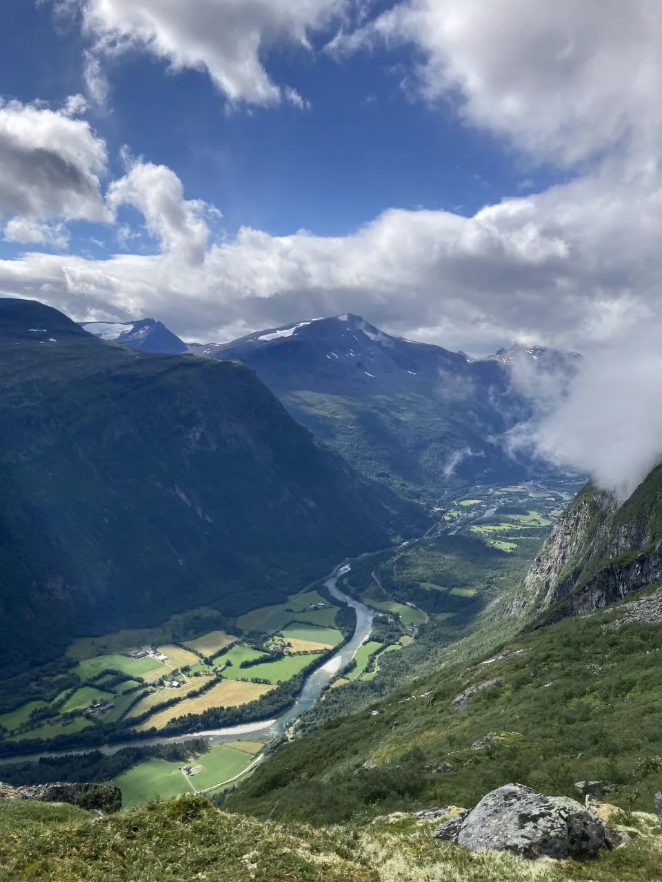 Valley view along trail with river, farmland, and distant mountains