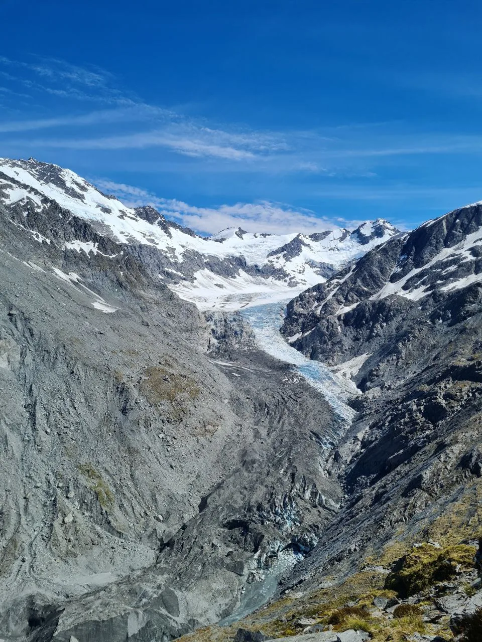Dart Glacier flows down a steep rocky valley on the Rees-Dart Track.